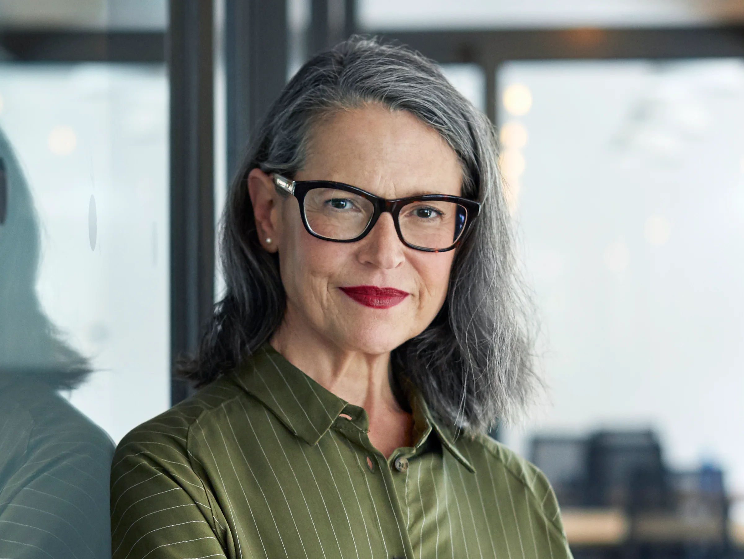 A woman in her fifties smiling, representing the menopause journey
